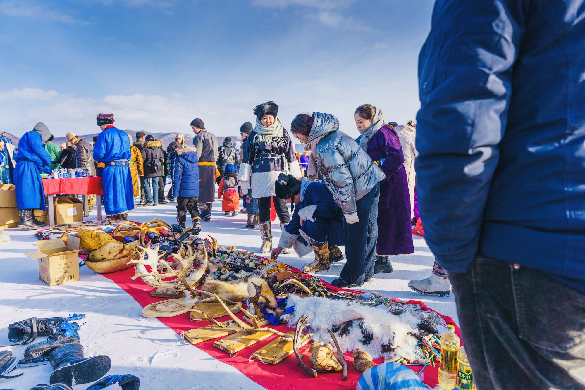 The Khuvsgul Ice Festival market bustles with nomadic people showcasing traditional goods.