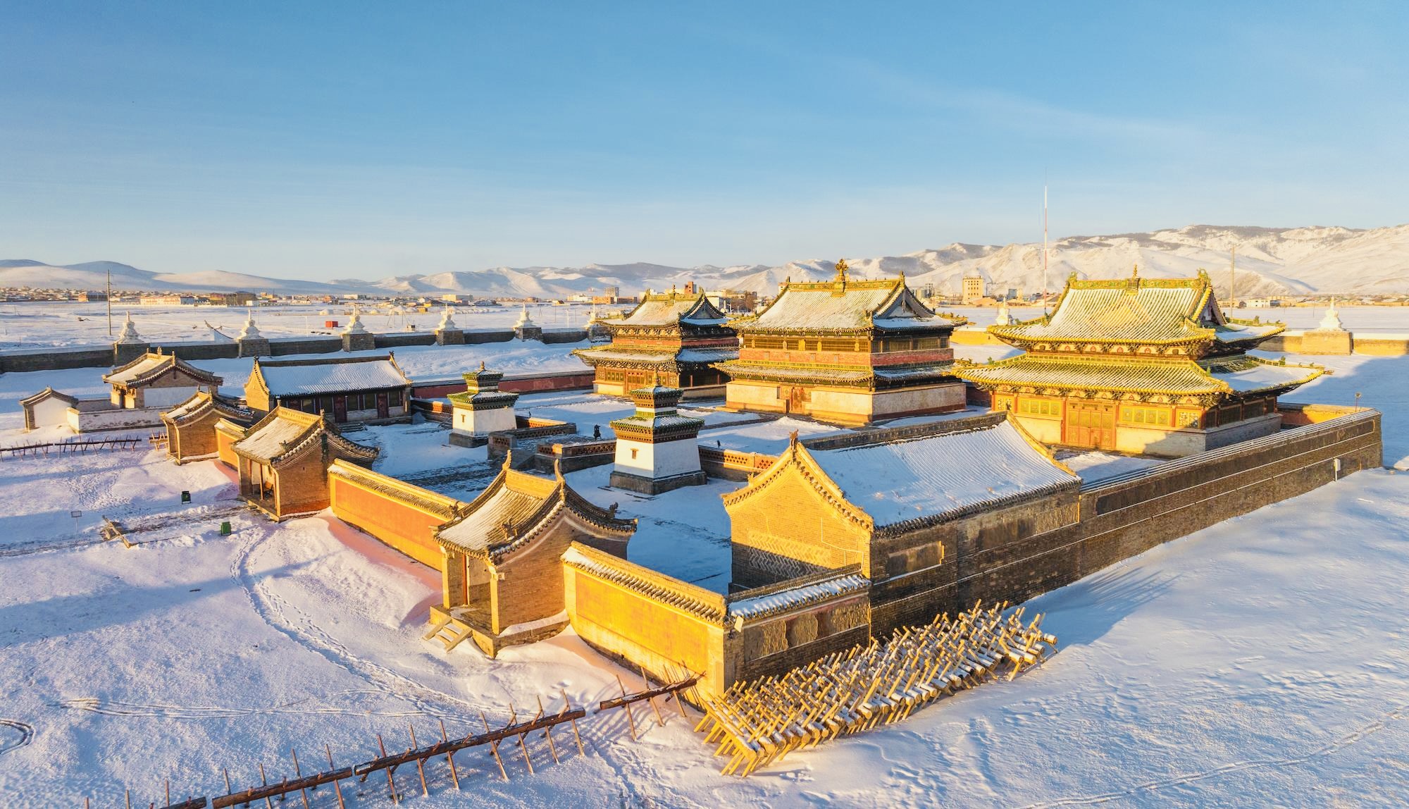 Golden monastery glowing under winter sun.