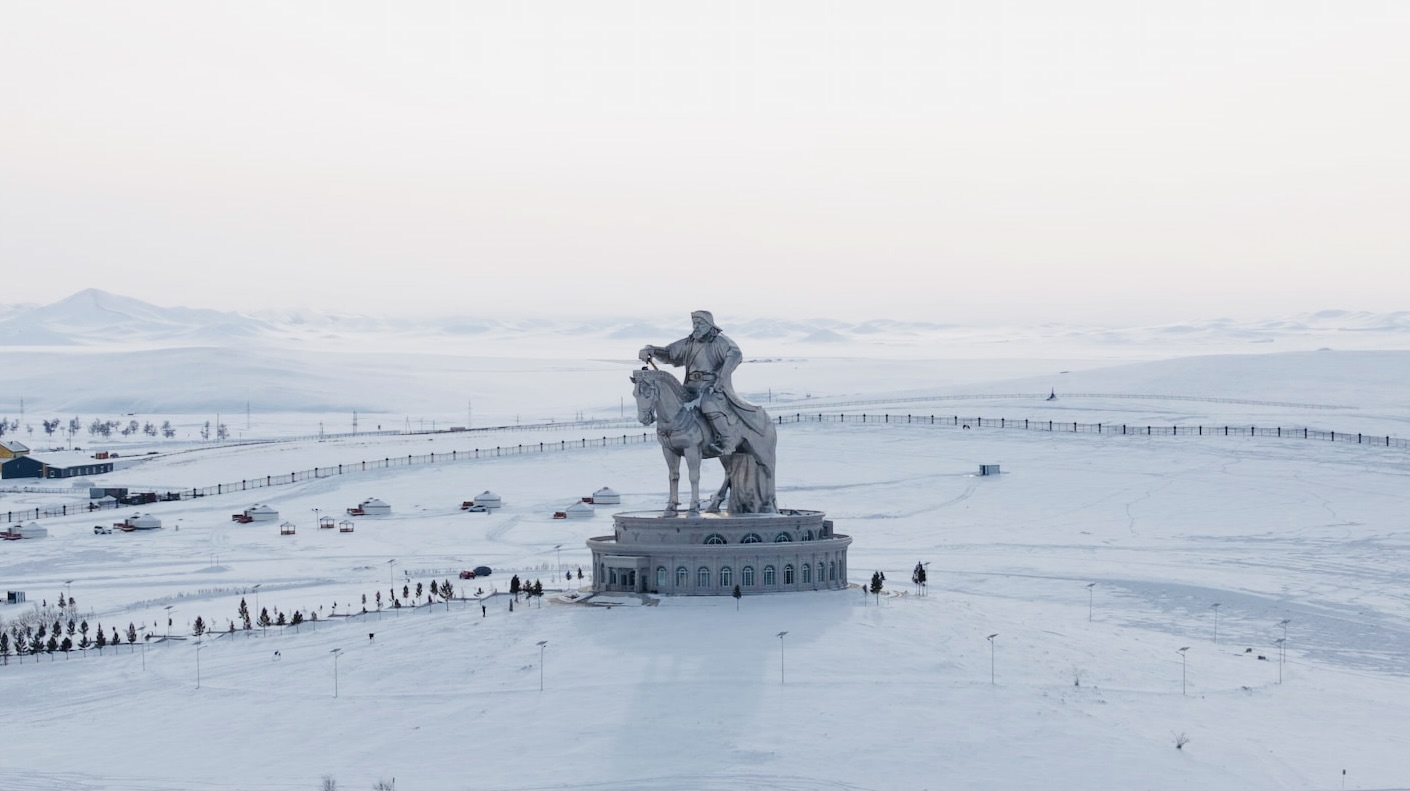 The Genghis Khan Statue rises majestically over the snowy Mongolian winter landscape.