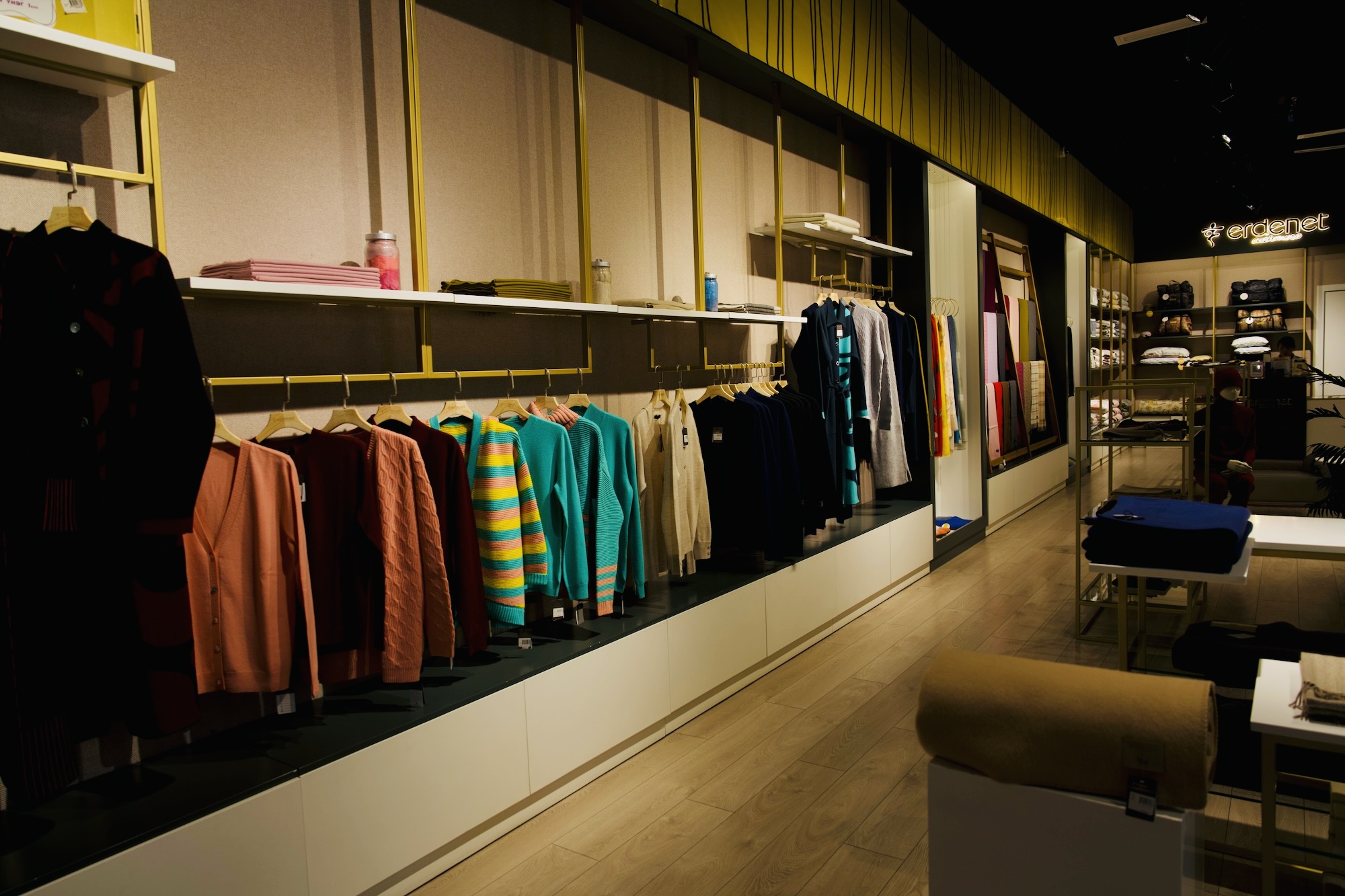 A vibrant display of warm woolen clothing in a Mongolian store, perfect for enduring the winter cold.